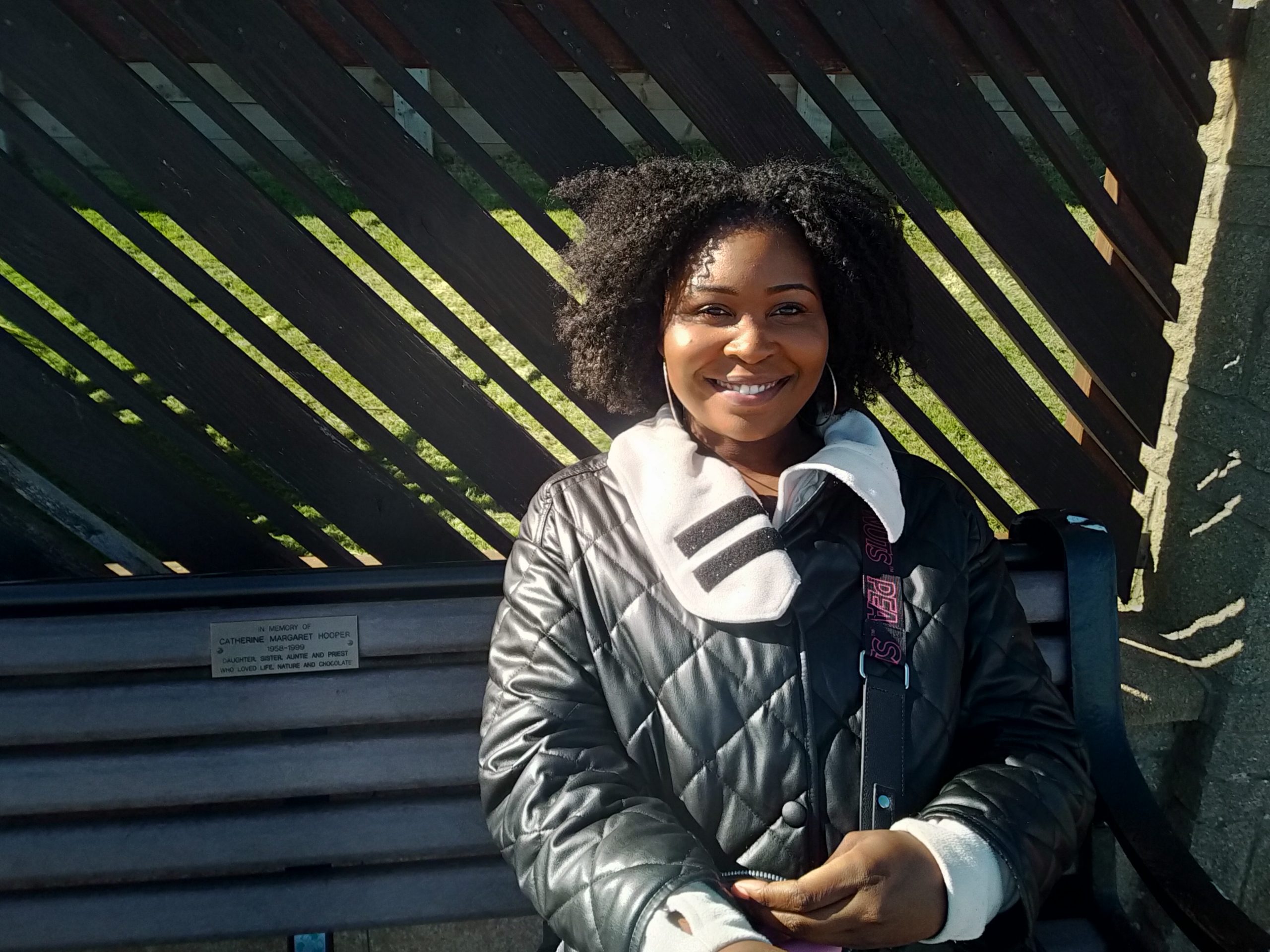 A LADY IN THE PARK ON A BENCH