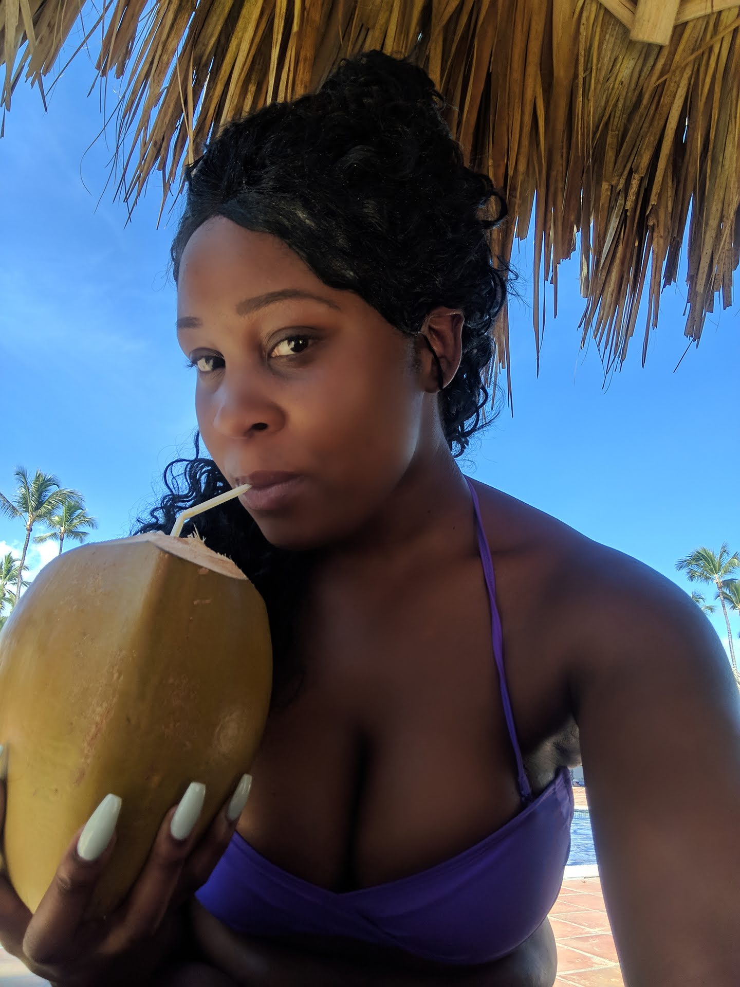 A Girl drinking Coconut in Dominican Republic
